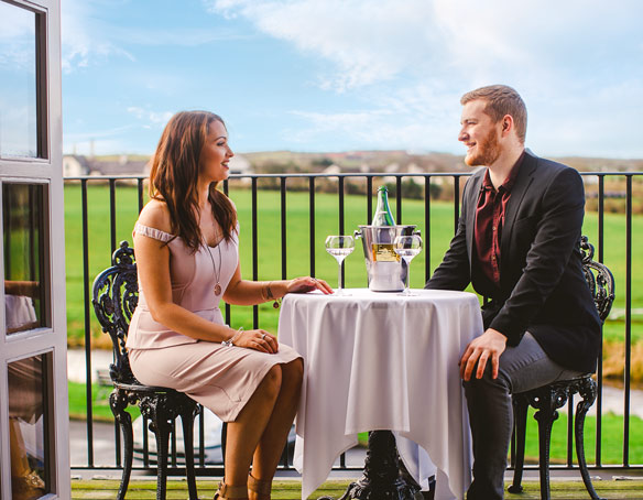 Two people drinking champagne al fresco in the Master Distiller's Suite at The Bushmills Inn